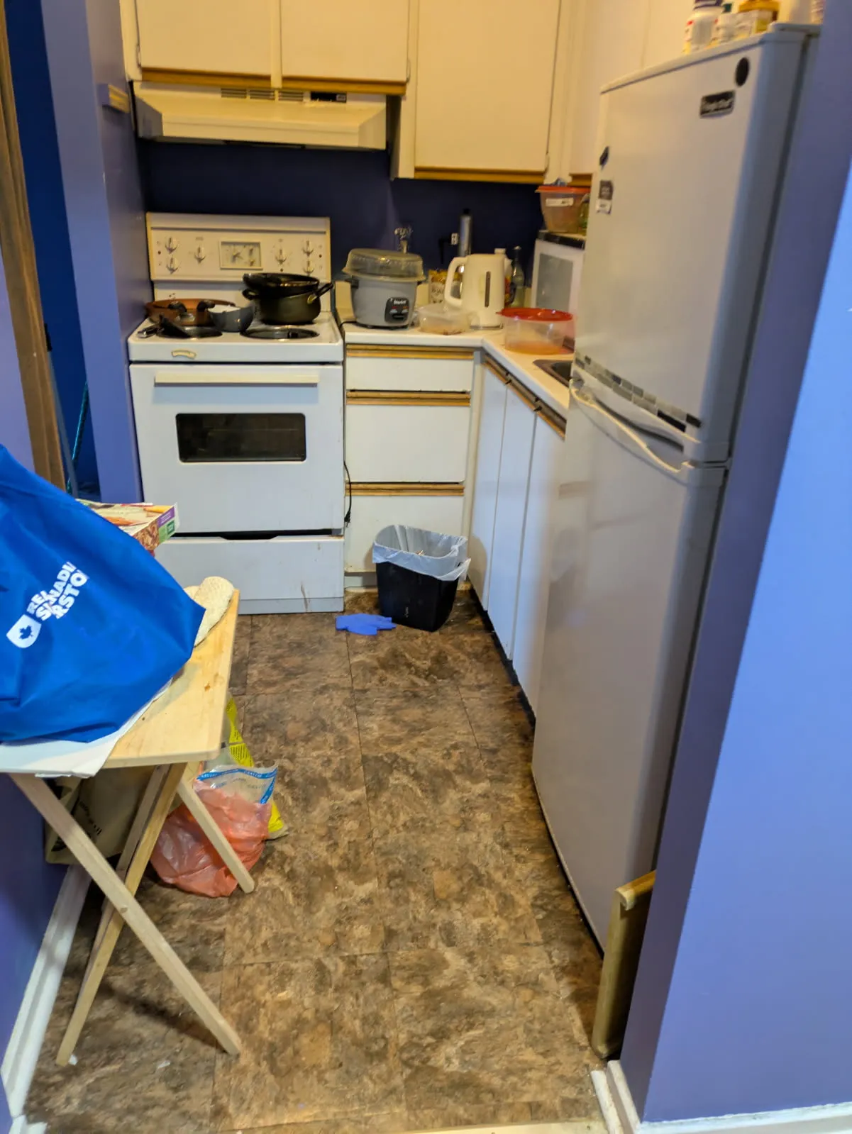 worried homeowner reviewing bills and mortgage statements at a kitchen table
