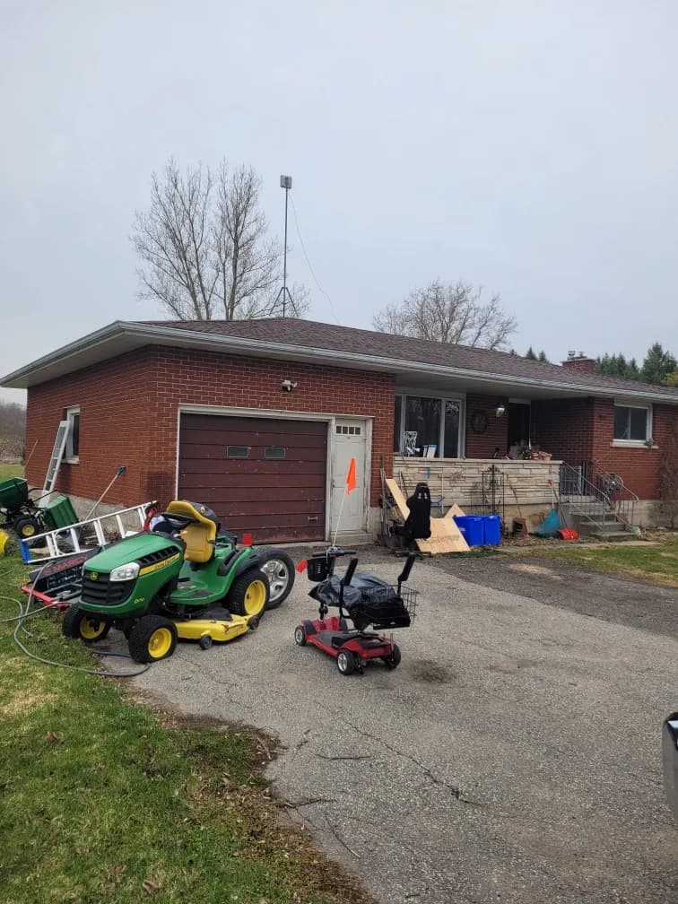 Ontario house with a for-sale sign on the front lawn