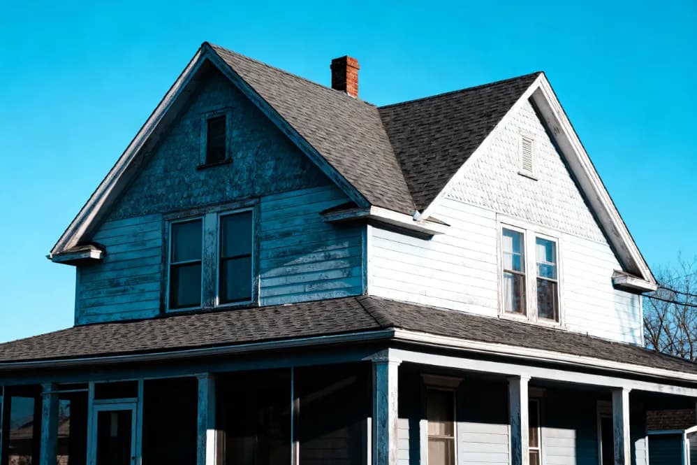 older brick bungalow with a weathered exterior on a quiet Ontario street