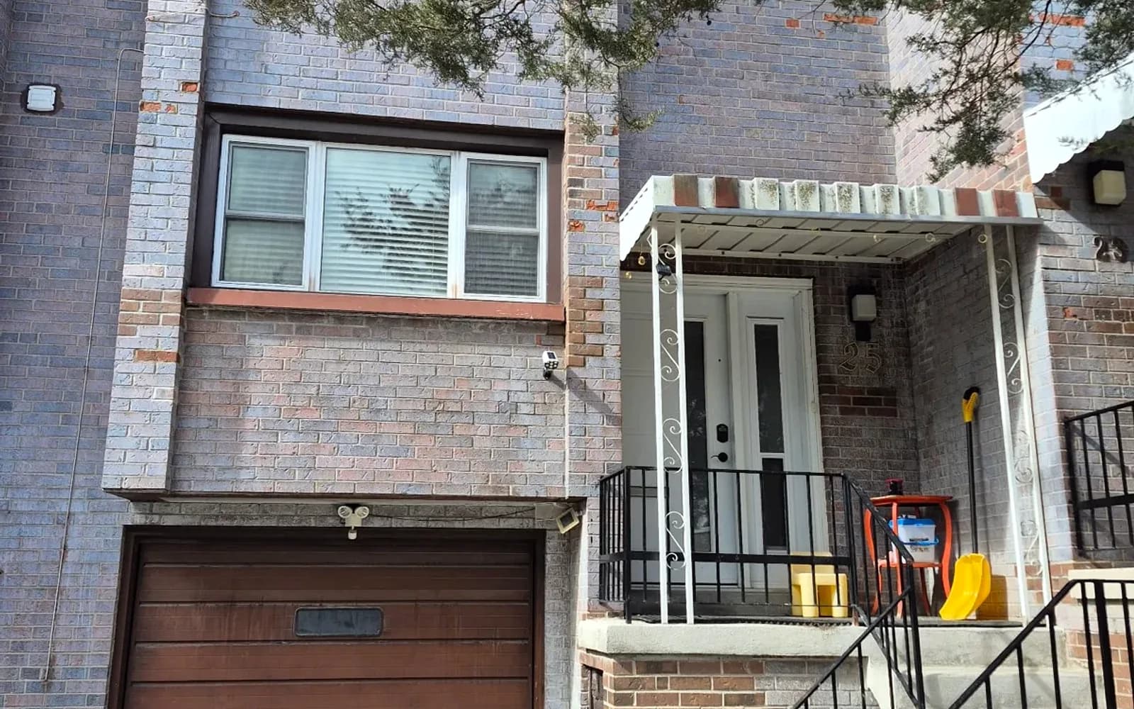 Brick townhome with a covered entry and garage in Burlington, Ontario