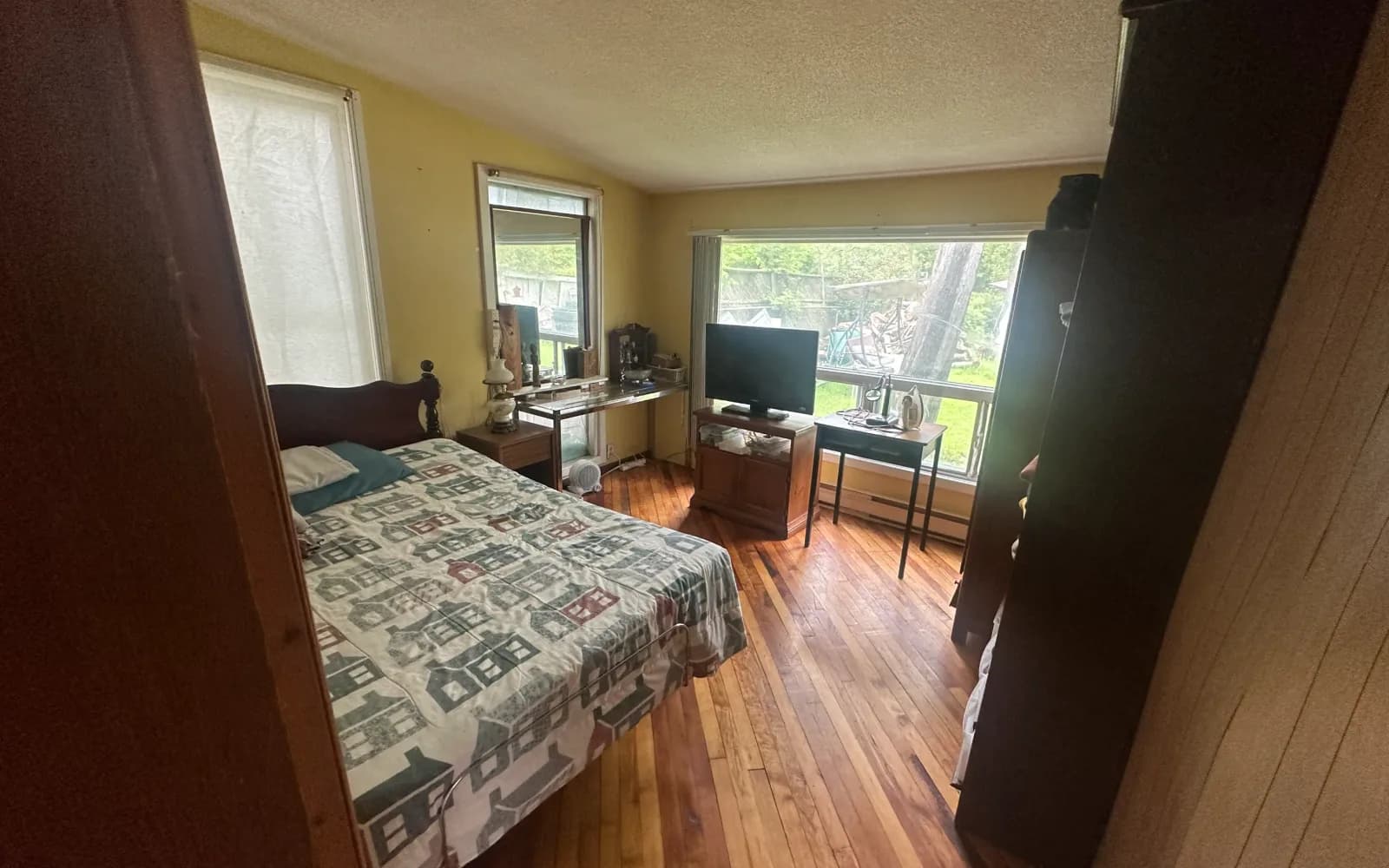 Red-brick century home with a covered porch on a quiet street in Ingersoll, Ontario