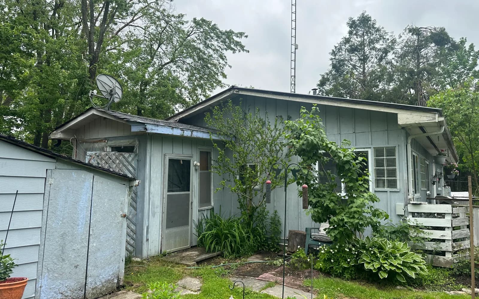 Brick bungalow with a wide front porch being sold as-is in Leamington, Ontario