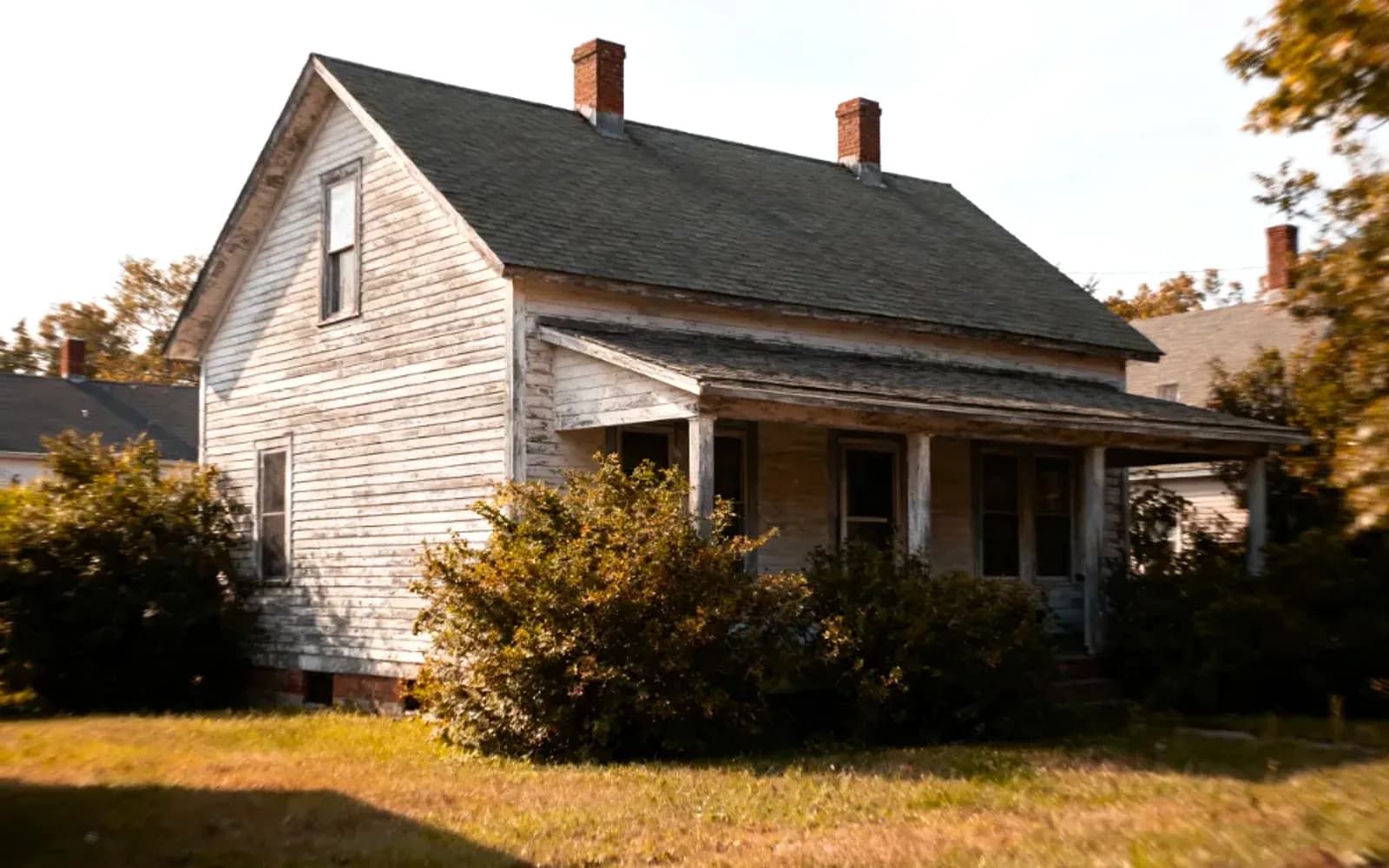 Older white clapboard home with a covered front porch, sold as-is to a cash buyer in Newmarket, Ontario